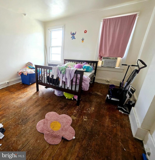 bedroom featuring wood-type flooring and cooling unit