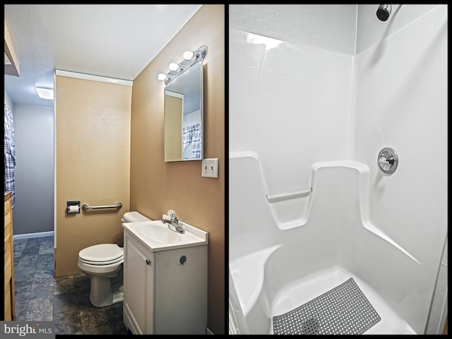 bathroom featuring walk in shower, vanity, and toilet