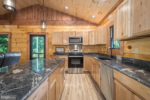 kitchen with decorative light fixtures, sink, light wood-type flooring, appliances with stainless steel finishes, and light brown cabinets