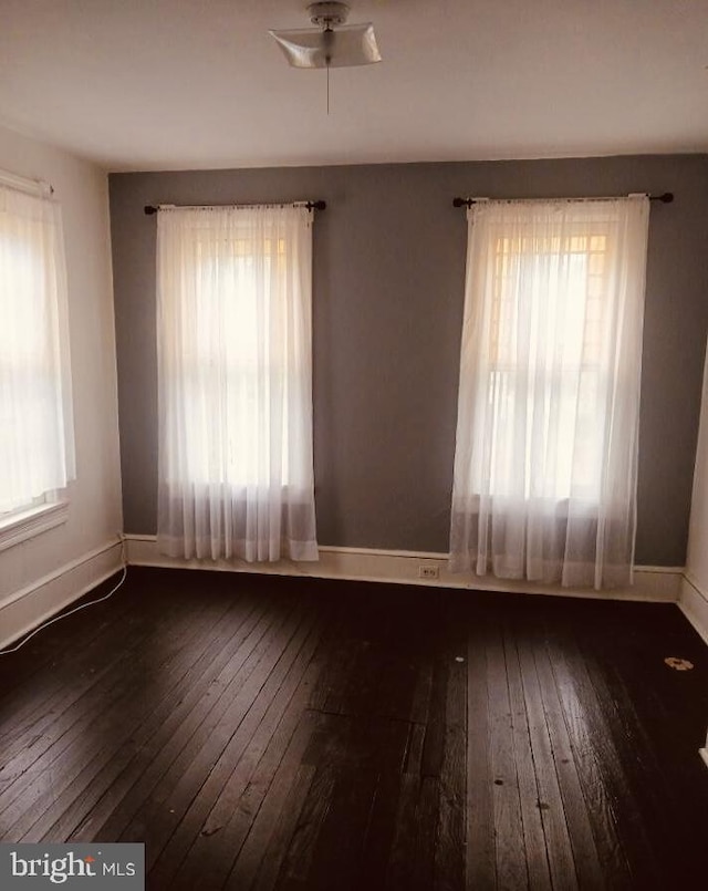 spare room with dark hardwood / wood-style floors