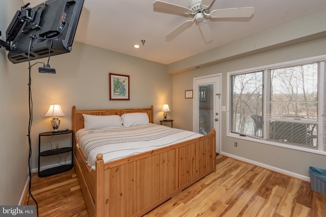 bedroom with light hardwood / wood-style flooring and ceiling fan