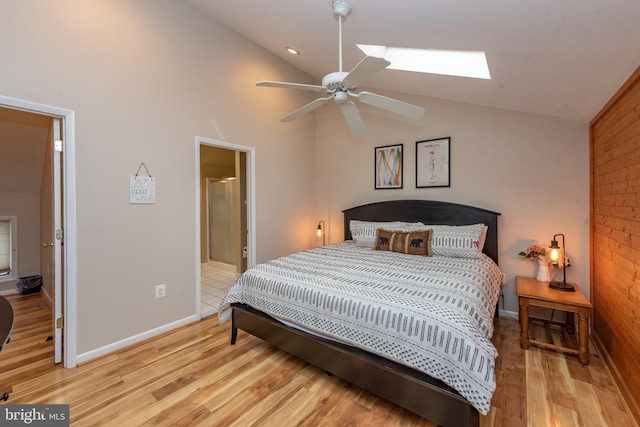 bedroom featuring lofted ceiling with skylight, ceiling fan, and light hardwood / wood-style floors