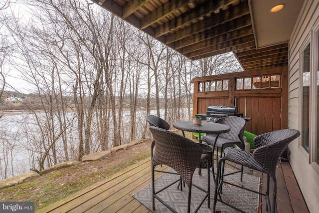 wooden terrace featuring a water view