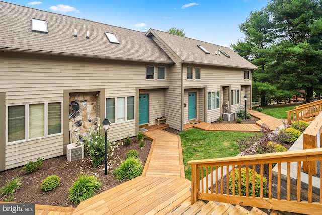 exterior space with central AC unit and a yard