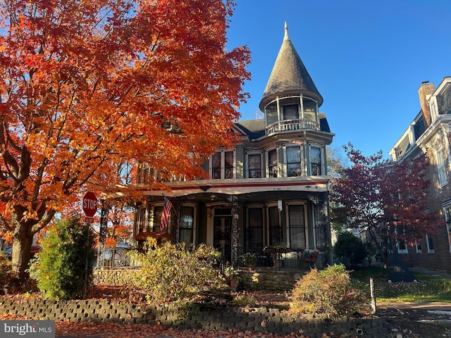 back of property featuring covered porch