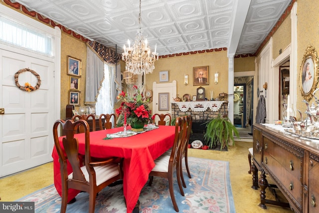 dining area with a fireplace and an inviting chandelier