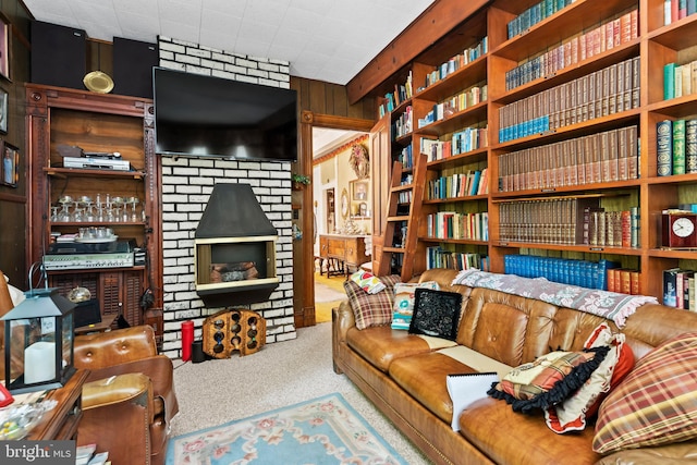 sitting room with carpet flooring and wooden walls