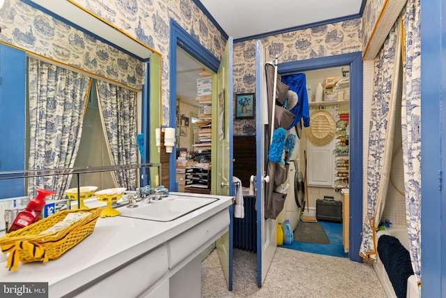 bathroom with washer / clothes dryer and vanity