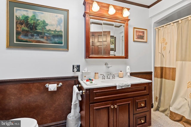 bathroom with a shower with curtain, vanity, toilet, and crown molding