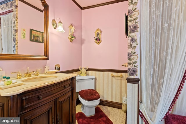 bathroom featuring vanity, toilet, and ornamental molding