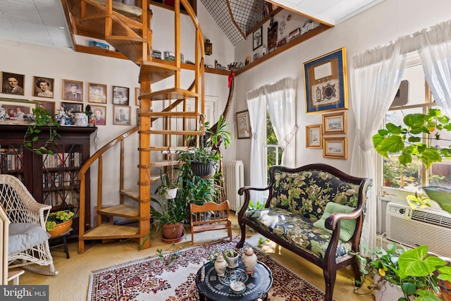 living area featuring carpet flooring, radiator, and a healthy amount of sunlight