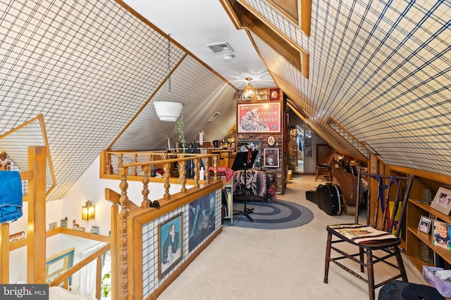 bonus room with light carpet, wood walls, and vaulted ceiling