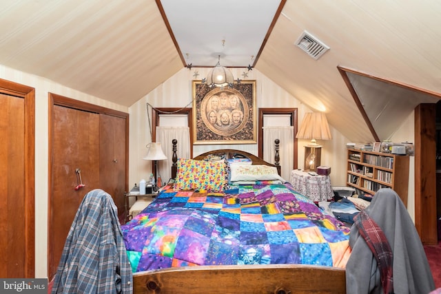 bedroom with vaulted ceiling and a closet