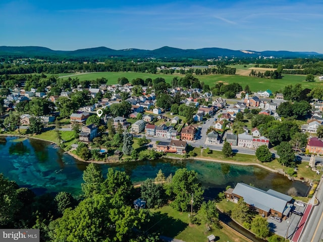 drone / aerial view with a water and mountain view