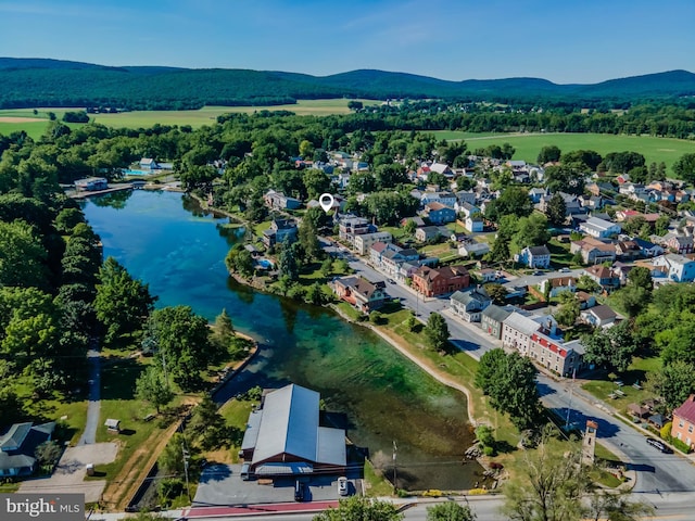 drone / aerial view featuring a water and mountain view