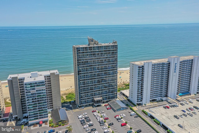 bird's eye view featuring a water view and a beach view