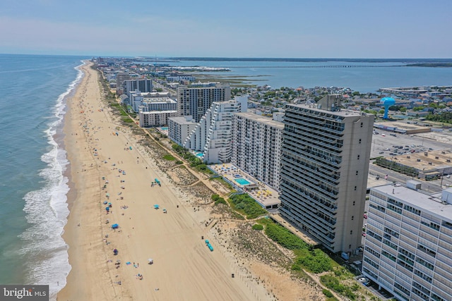 birds eye view of property with a water view and a beach view