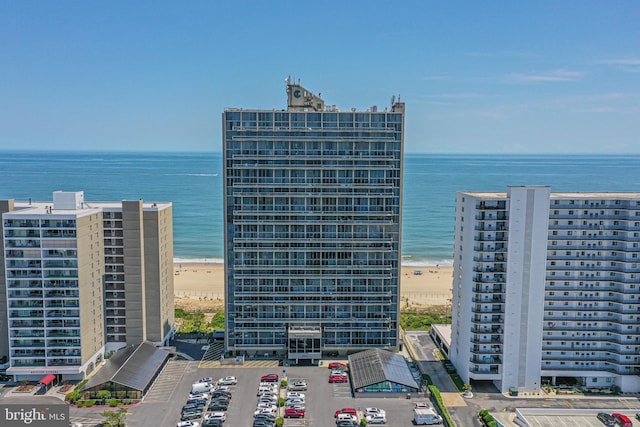 birds eye view of property featuring a water view and a beach view