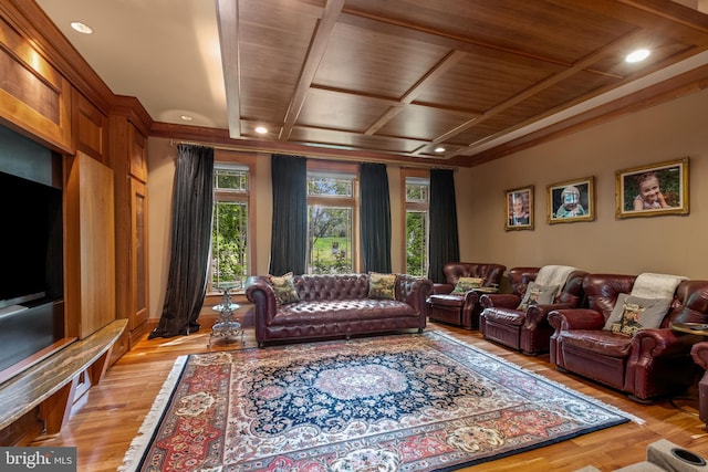 cinema featuring light wood-type flooring, wooden ceiling, crown molding, and coffered ceiling