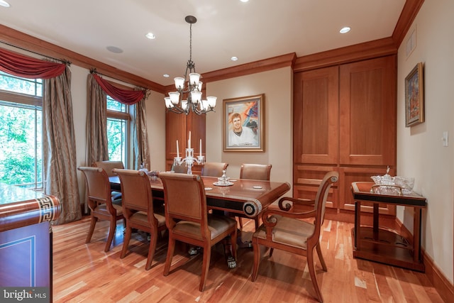 dining space with an inviting chandelier, light hardwood / wood-style flooring, and ornamental molding