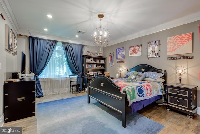 bedroom featuring a chandelier, hardwood / wood-style flooring, and crown molding