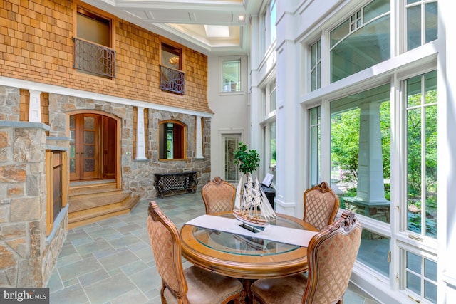 dining room with a towering ceiling