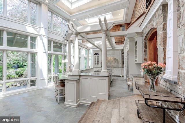 sunroom / solarium with ornate columns and coffered ceiling