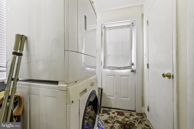 clothes washing area with stacked washer and clothes dryer