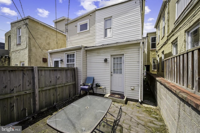 back of house with a patio