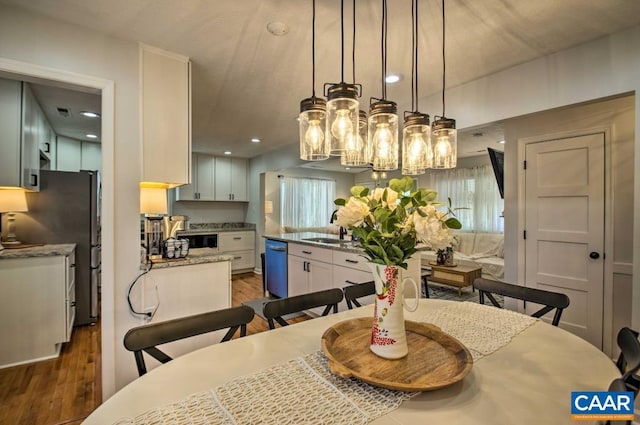 dining room with dark hardwood / wood-style floors and sink