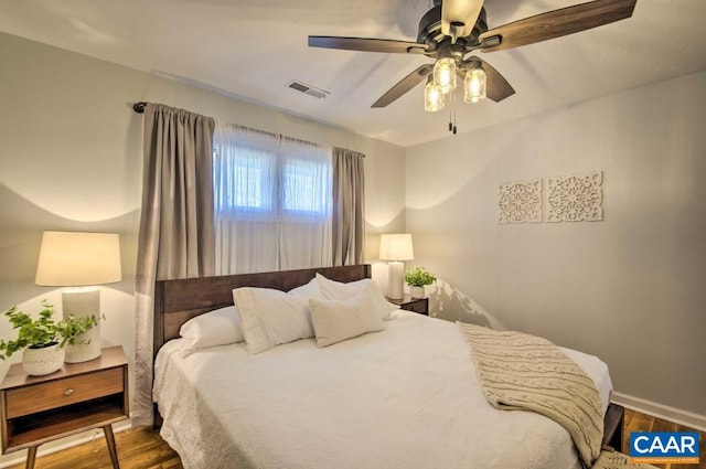 bedroom featuring ceiling fan and dark hardwood / wood-style floors