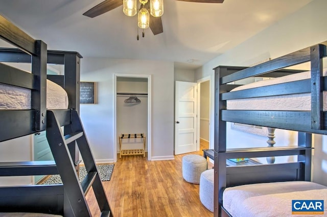 bedroom with wood-type flooring, a closet, and ceiling fan