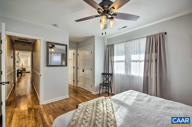 bedroom with dark hardwood / wood-style flooring and ceiling fan