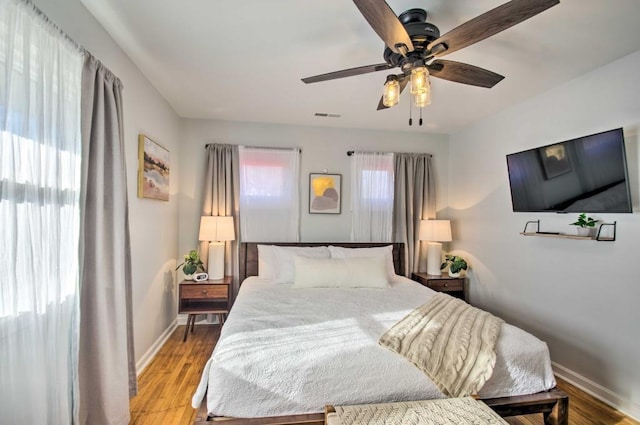 bedroom with ceiling fan and light hardwood / wood-style floors