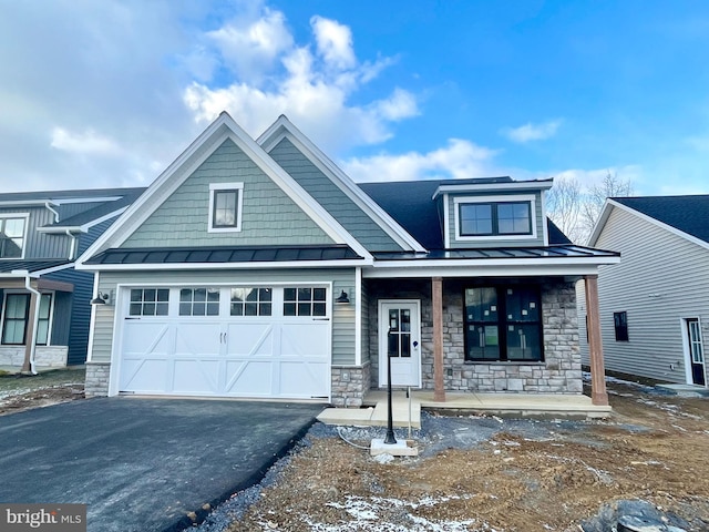 craftsman-style home with covered porch and a garage