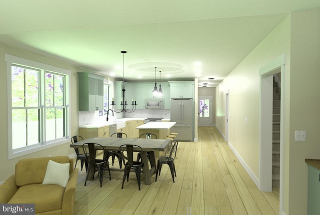 dining room with sink and light hardwood / wood-style floors