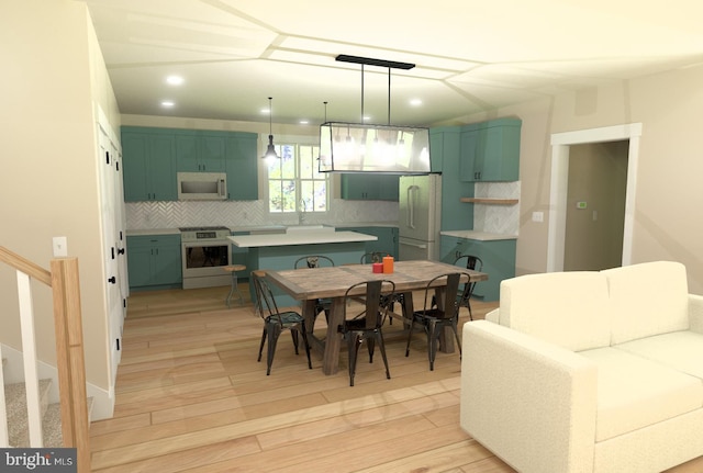 dining area with light hardwood / wood-style flooring and sink