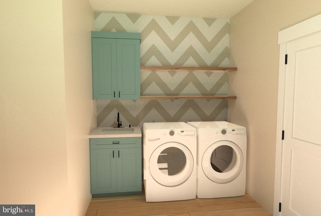 washroom featuring sink, cabinets, light wood-type flooring, and independent washer and dryer