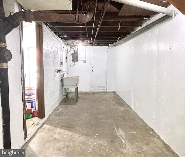 basement featuring sink and electric panel