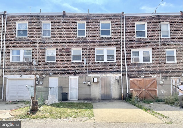 view of front facade with a wall mounted AC