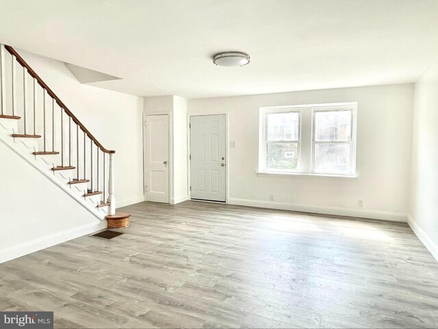 foyer entrance with light wood-type flooring