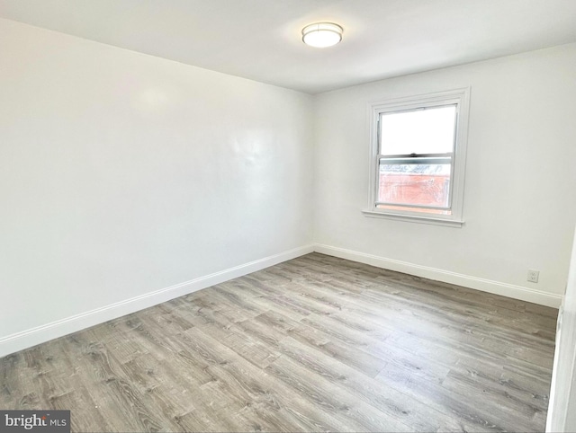 spare room with light wood-type flooring