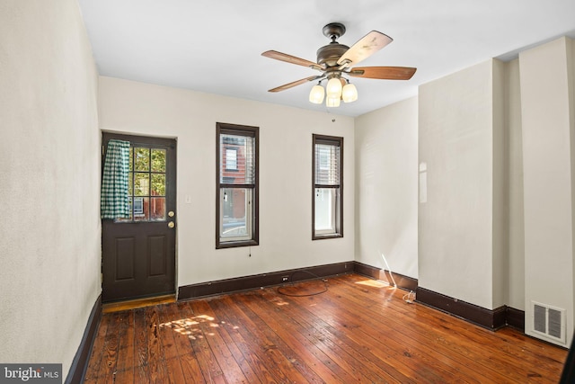 foyer with ceiling fan and dark wood-type flooring