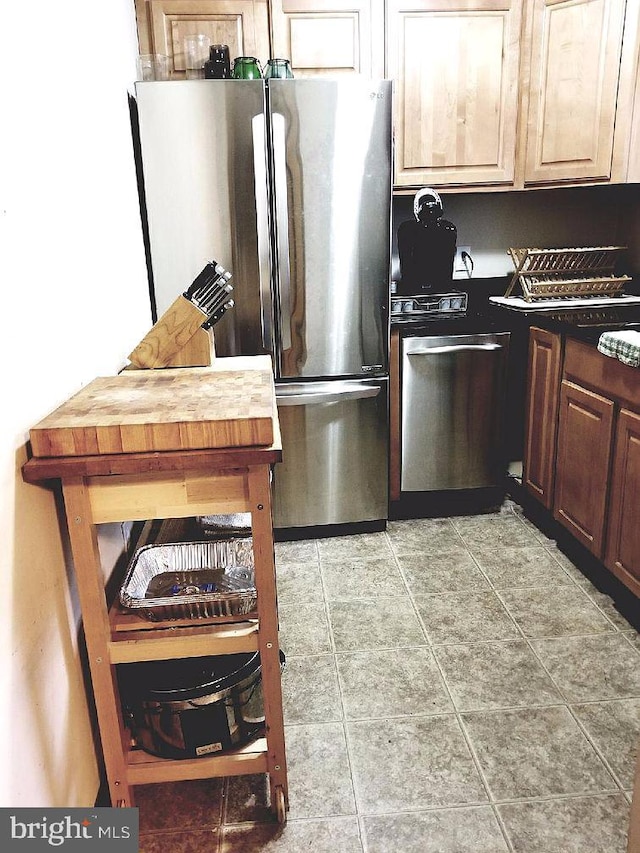 kitchen featuring wood counters and appliances with stainless steel finishes