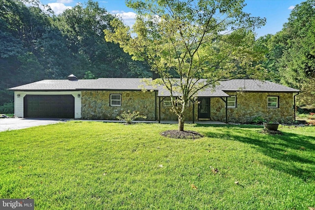 ranch-style home featuring a garage and a front lawn