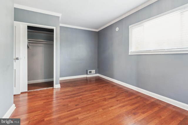 unfurnished bedroom with hardwood / wood-style floors and ornamental molding