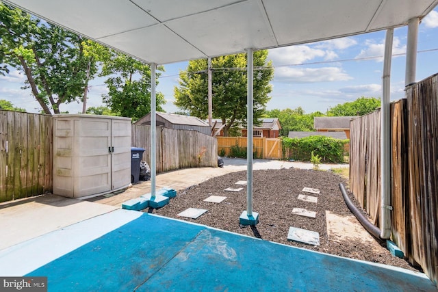 view of patio / terrace featuring a storage shed