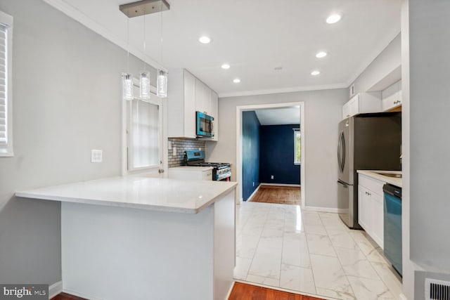 kitchen with kitchen peninsula, white cabinetry, hanging light fixtures, and stainless steel appliances