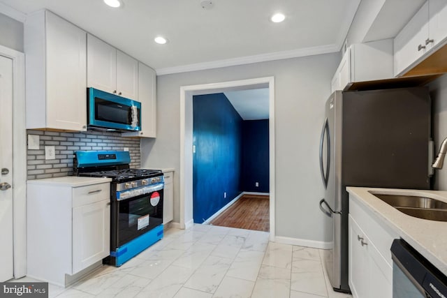 kitchen with white cabinetry, sink, appliances with stainless steel finishes, and tasteful backsplash