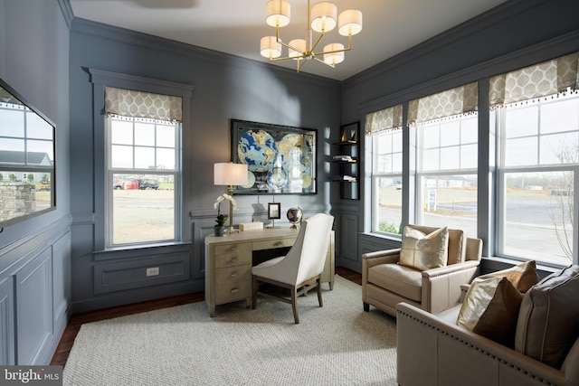 office space featuring a wealth of natural light, crown molding, a chandelier, and light wood-type flooring